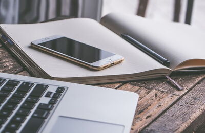 Smartphone, diary, laptop on the table